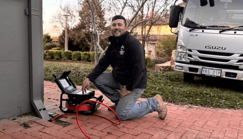 Connor running a drain machine from the Capital Apex truck